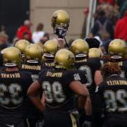 Buffs football players gather before a game.