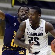 Colorado's McKinley 莱特 IV, 左, drives past a Cal player during a Pac-12 Conference basketball game