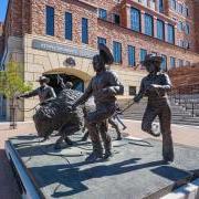 Sculpture depicting Ralphie and her handlers